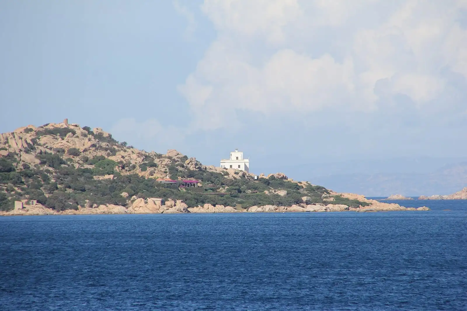 The white lighthouse at Punta Sardegna near Palau, seen from a boat